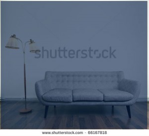 photo a modern gray sofa and a retro lamp with two heads against bright background on wooden floor