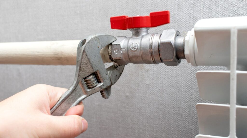 Plumber using adjustable wrench - How Clean Water Pipes Keep Your Home Safe and Healthy