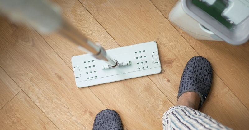 Man learning How To Clean Wood Tile Floors